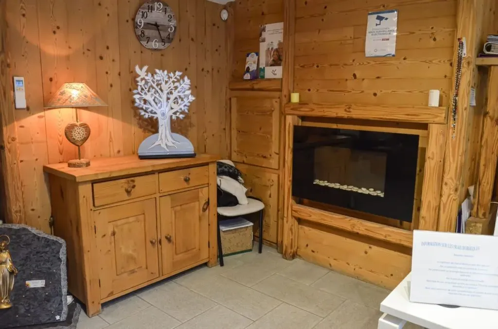 Salon d'accueil chaleureux avec mobilier en bois et cheminée d'ambiance